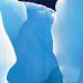 Close-up view of a glacier crevasse with smooth, sculpted blue ice walls illuminated by sunlight directly representing the concept of adhd and slow brain.